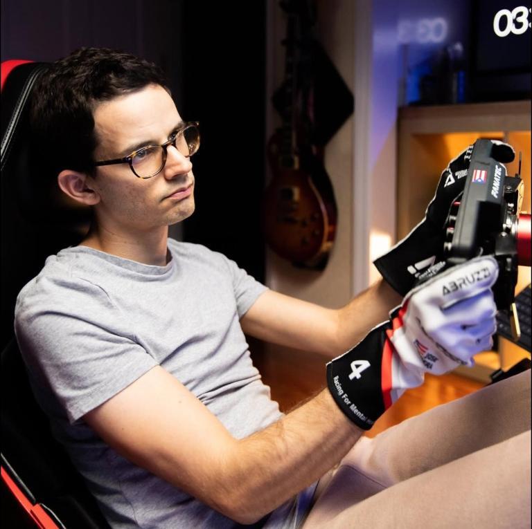 Jose at his first proper sim rig with racing gloves on a Fanatec wheel