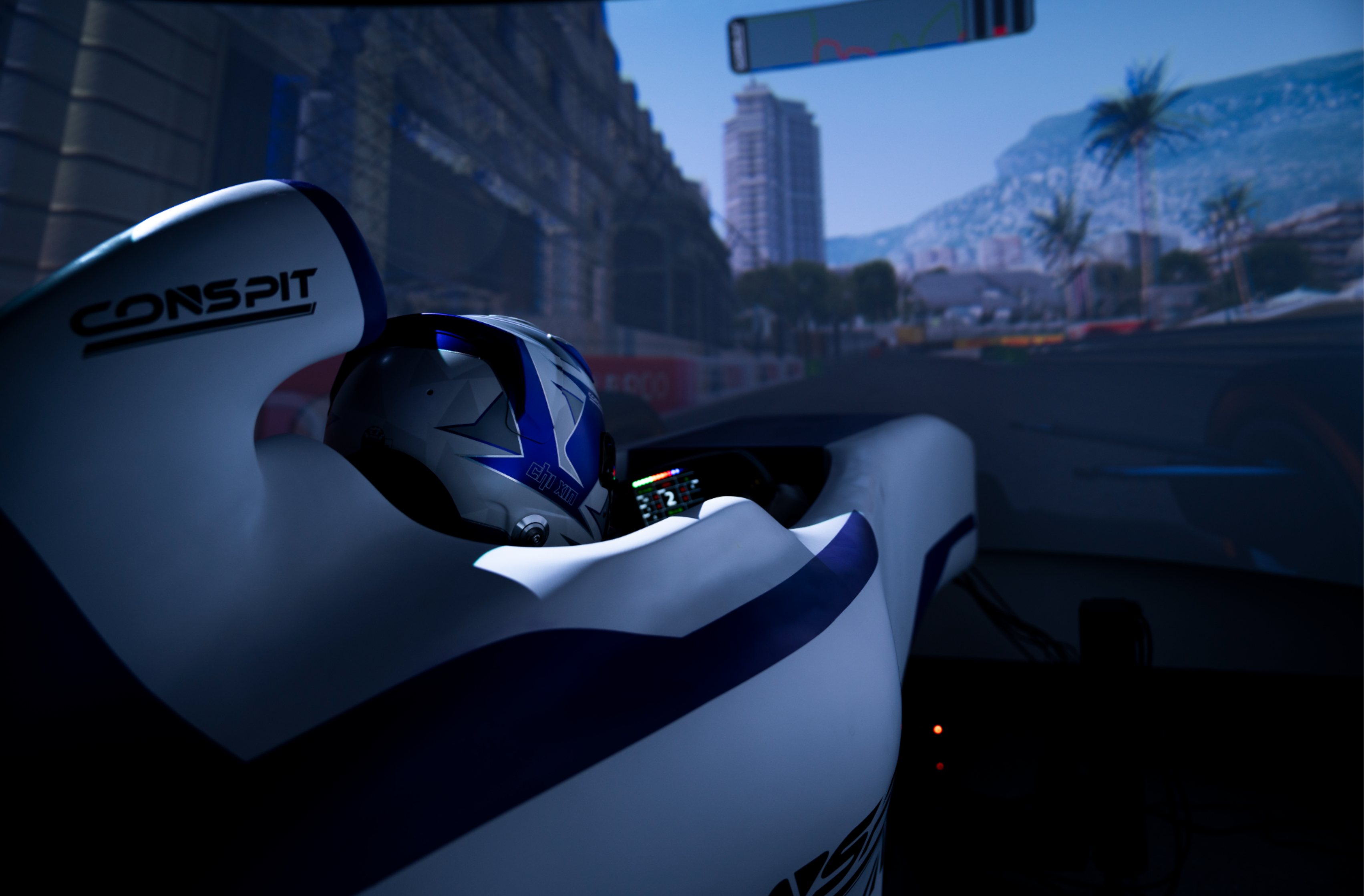 Driver in a helmet racing in the CONSPIT FC-Lite formula cockpit