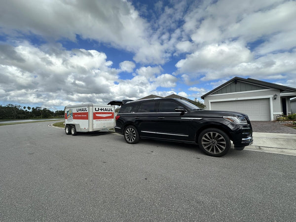 SUV towing a U-Haul trailer for the move to Daytona Beach