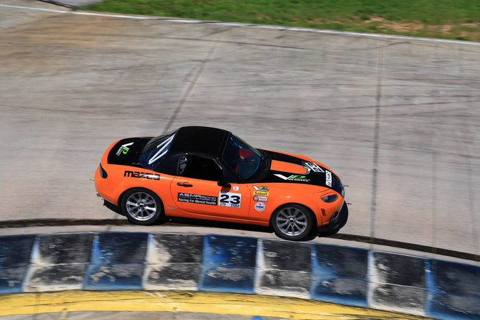 The number 23 MX-5 on the banking at Sebring
