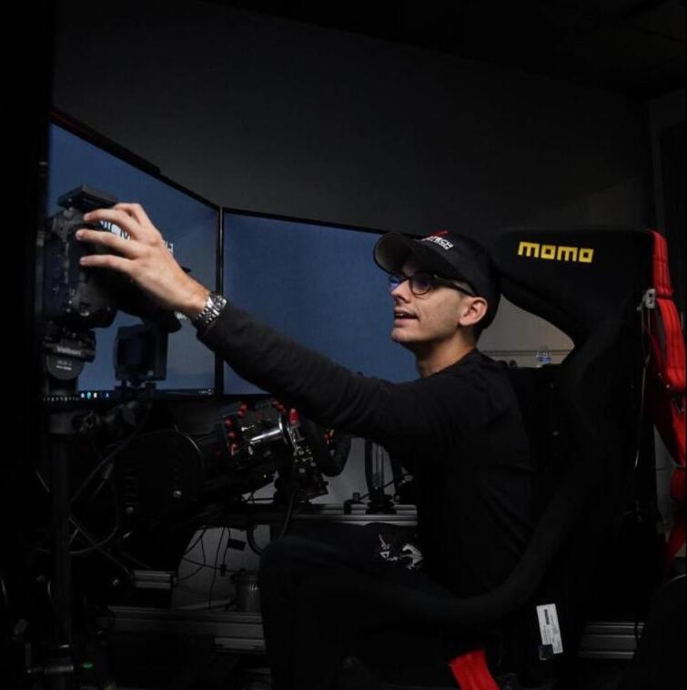 Jose adjusting a camera at his sim rig while filming content